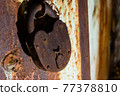 Rusty old padlock on an old metal door 77378810