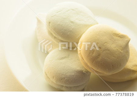 Delicious colored marshmallows with different flavors on a round plate 77378819