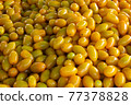 Yellow tomatoes selling fresh vegetables 77378828