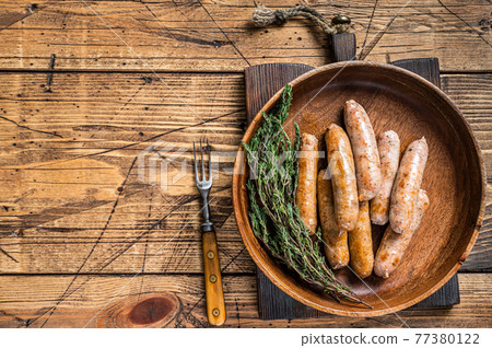 Fried Chorizo and Bratwurst sausages in a wooden plate. wooden background. Top View. Copy space Fried Chorizo and Bratwurst sausages in a wooden plate. wooden background. Top View. Copy space 77380122