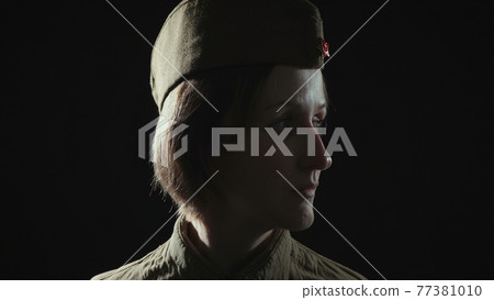Photo of woman wearing soviet red army uniform in shadow Photo of woman wearing soviet red army uniform in shadow 77381010