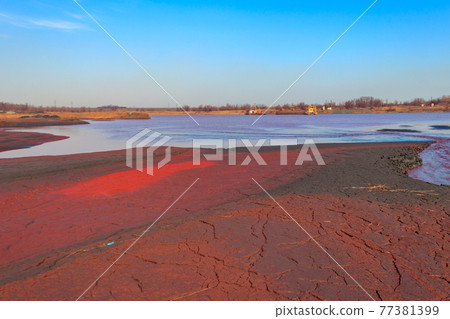 Technical settler of industrial water of mining industry with red soil polluted with iron ore waste in Kryvyi Rih, Ukraine 77381399