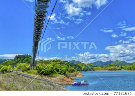 Spring Miyagase dam lake suspension bridge and pleasure boat Kanagawa Prefecture 77381685