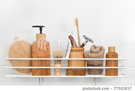 Wooden bottles of grooming care products in bath 77382657