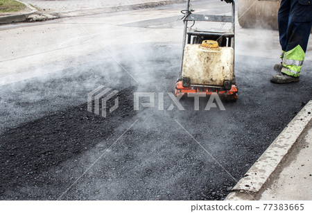 asphalt rammer. laying the road surface 77383665