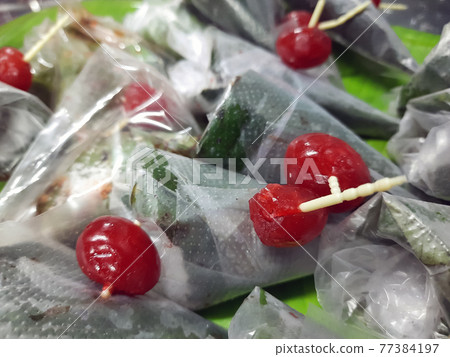 sweet paan wrapped in betel leaf, often used as an after dinner digestive. sweet paan wrapped in betel leaf, often used as an after dinner digestive. 77384197