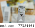 Rapid Antigen Corona Test Showing A Negative Result In Front of Two Tickets 77384461