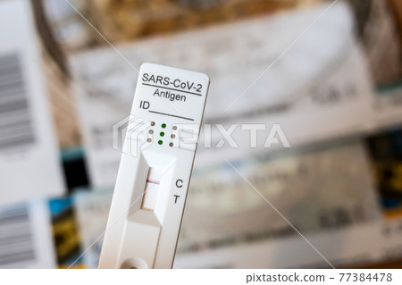 Rapid Antigen Corona Test Showing A Negative Result In Front of Two Tickets Rapid Antigen Corona Test Showing A Negative Result In Front of Two Tickets 77384478