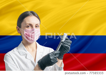 Girl doctor prepares vaccination against the background of the Colombia flag. Vaccination concept Colombia Girl doctor prepares vaccination against the background of the Colombia flag. Vaccination concept Colombia 77385333