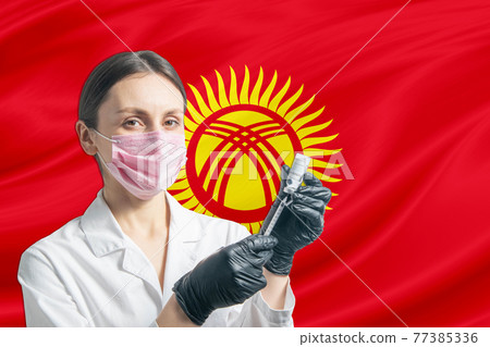 Girl doctor prepares vaccination against the background of the Kyrgyzstan flag. Vaccination concept Kyrgyzstan Girl doctor prepares vaccination against the background of the Kyrgyzstan flag. Vaccination concept Kyrgyzstan 77385336