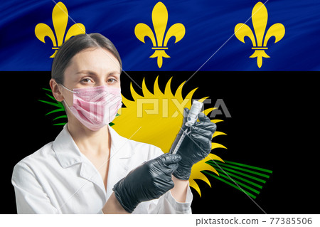 Girl doctor prepares vaccination against the background of the Guadeloupe flag. Vaccination concept Guadeloupe Girl doctor prepares vaccination against the background of the Guadeloupe flag. Vaccination concept Guadeloupe 77385506