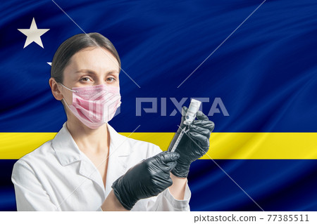 Girl doctor prepares vaccination against the background of the Curacao flag. Vaccination concept Curacao Girl doctor prepares vaccination against the background of the Curacao flag. Vaccination concept Curacao 77385511
