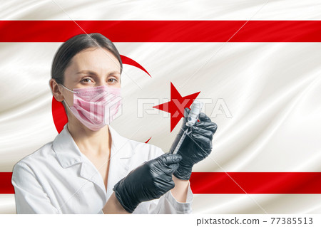 Girl doctor prepares vaccination against the background of the Turkish Republic of Northern Cyprus flag. Vaccination concept Turkish Republic of Northern Cyprus 77385513