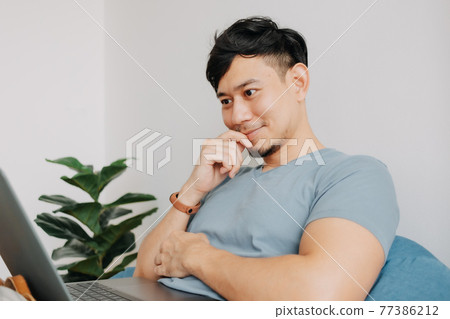 Happy man work with computer laptop while stay at home. Work at home. Happy man work with computer laptop while stay at home. Work at home. 77386212