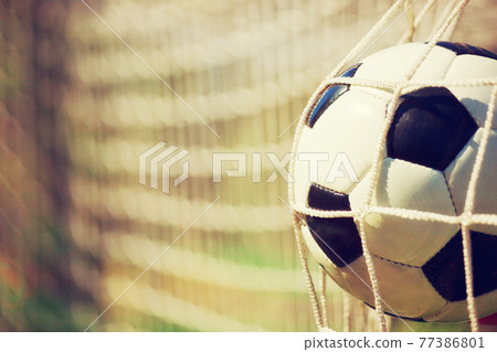 Soccer ball in the net of a goal. Soccer concept Soccer ball in the net of a goal. Soccer concept 77386801