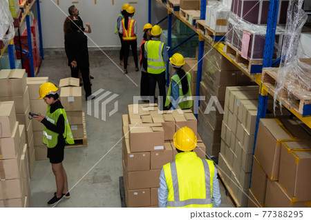 Many people , workers and manger work in warehouse or storehouse Many people , workers and manger work in warehouse or storehouse 77388295