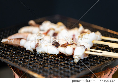 Crested squid skewers charcoal-grilled on a shichirin Crested squid skewers charcoal-grilled on a shichirin 77390332