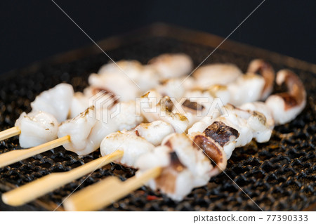 Crested squid skewers charcoal-grilled on a shichirin Crested squid skewers charcoal-grilled on a shichirin 77390333