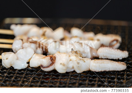 Crested squid skewers charcoal-grilled on a shichirin Crested squid skewers charcoal-grilled on a shichirin 77390335