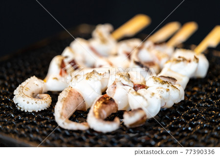 Crested squid skewers charcoal-grilled on a shichirin Crested squid skewers charcoal-grilled on a shichirin 77390336