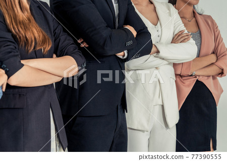 Businesswomen and businessman standing in office. Businesswomen and businessman standing in office. 77390555
