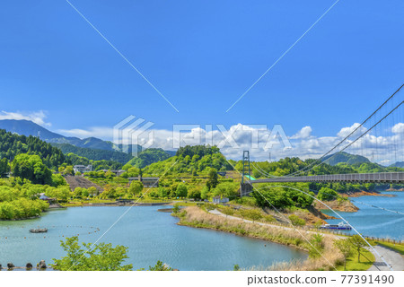 Spring Miyagase dam lake, dam lake, suspension bridge and blue sky, Kanagawa Prefecture 77391490