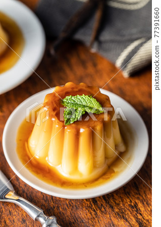 Sweet vanilla pudding. Sweet dessert with caramel topping. Sweet vanilla pudding. Sweet dessert with caramel topping. 77391660
