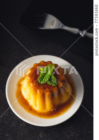 Sweet vanilla pudding. Sweet dessert with caramel topping. 77391668