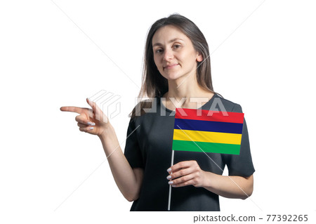Happy young white woman holding flag Mauritius and points to the left isolated on a white background Happy young white woman holding flag Mauritius and points to the left isolated on a white background 77392265