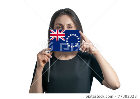 Happy young white woman holding flag Cook Islands flag and covers her face with it isolated on a white background Happy young white woman holding flag Cook Islands flag and covers her face with it isolated on a white background 77392328