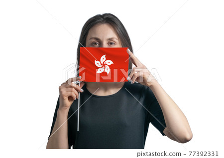 Happy young white woman holding flag Hong Kong flag and covers her face with it isolated on a white background 77392331