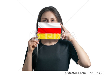 Happy young white woman holding flag South Ossetia flag and covers her face with it isolated on a white background 77392333