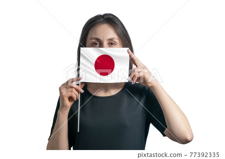 Happy young white woman holding flag Japan flag and covers her face with it isolated on a white background Happy young white woman holding flag Japan flag and covers her face with it isolated on a white background 77392335