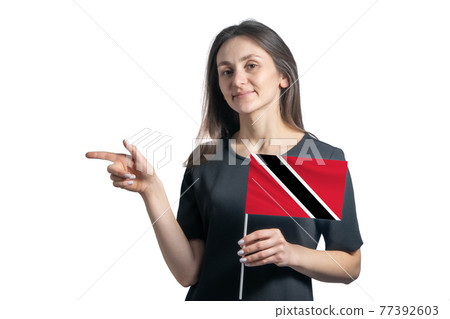 Happy young white woman holding flag Trinidad and Tobago and points to the left isolated on a white background Happy young white woman holding flag Trinidad and Tobago and points to the left isolated on a white background 77392603