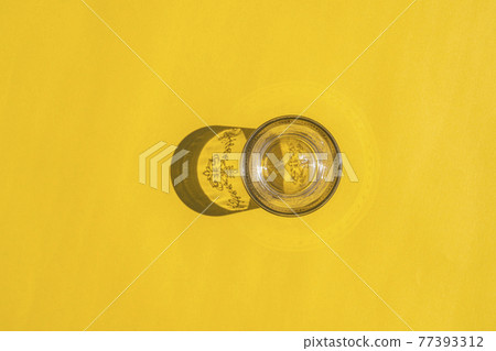 glass with a hard shadow on a colored background glass with a hard shadow on a colored background 77393312