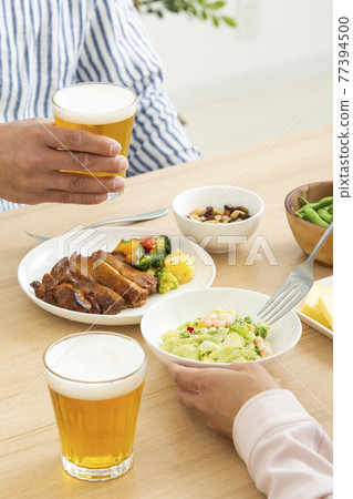 A couple drinking beer A couple drinking beer 77394500