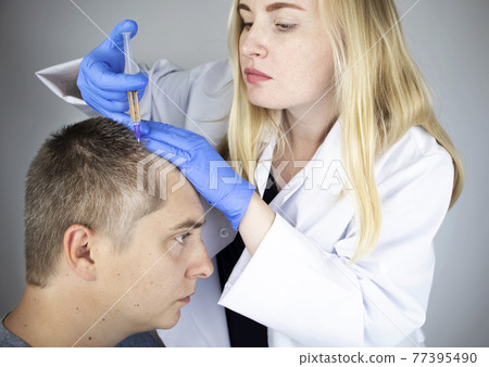 The doctor trichologist conducts mesotherapy or plasma therapy. Treatment of alopecia. Hair loss, alopecia, pruritus, burning head or seborrhea 77395490