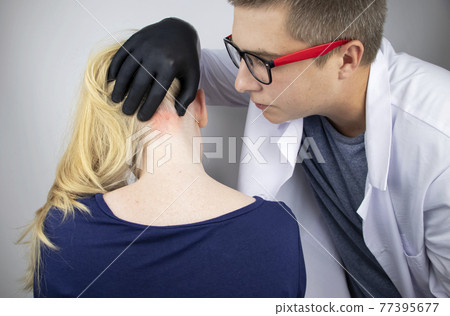 A doctor trichologist conducts a study of the hair of a blonde. Alopecia treatment. Hair loss, alopecia, itching, burning in the head, seborrhea or brittle ends 77395677