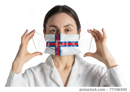Respirator with flag of Faroe Islands Doctor puts on medical face mask isolated on white background Respirator with flag of Faroe Islands Doctor puts on medical face mask isolated on white background 77396998