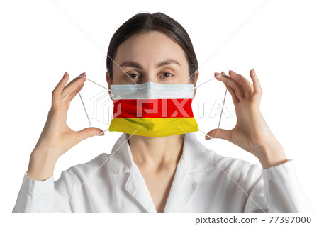 Respirator with flag of South Ossetia Doctor puts on medical face mask isolated on white background Respirator with flag of South Ossetia Doctor puts on medical face mask isolated on white background 77397000