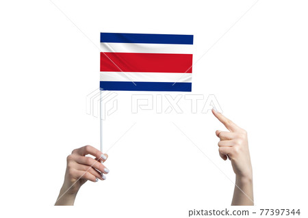 A beautiful female hand holds a Costa Rica flag to which she shows the finger of her other hand, isolated on white background A beautiful female hand holds a Costa Rica flag to which she shows the finger of her other hand, isolated on white background 77397344