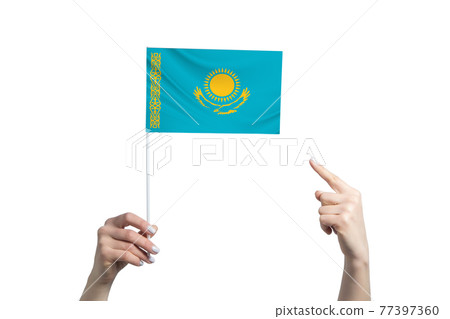 A beautiful female hand holds a Kazakhstan flag to which she shows the finger of her other hand, isolated on white background 77397360