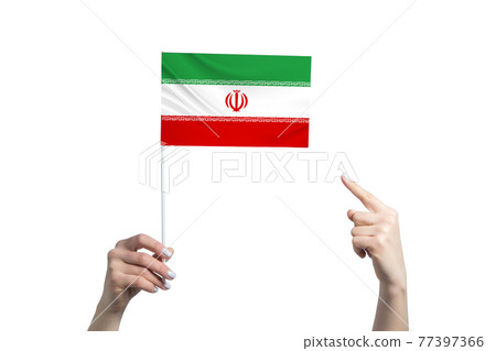 A beautiful female hand holds a Iran flag to which she shows the finger of her other hand, isolated on white background A beautiful female hand holds a Iran flag to which she shows the finger of her other hand, isolated on white background 77397366