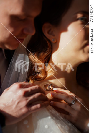 wedding rings on the bride's collarbone. traditional wedding decorations 77398784