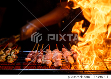 Variety of Barbecue skewers meat kebabs with vegetables on hot flaming grill 77398991