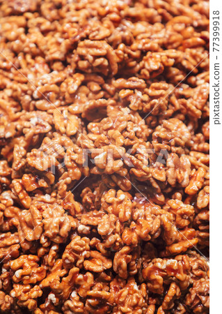 Heap of walnuts in sugar glaze. Sweet walnut dessert (Selective focus) Heap of walnuts in sugar glaze. Sweet walnut dessert (Selective focus) 77399918
