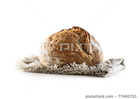 Isolated freshly baked crunchy yeast bread loaf lying on the flax dish cloth Isolated freshly baked crunchy yeast bread loaf lying on the flax dish cloth 77400785