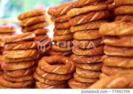 A counter filled with simit bagels, a popular street food in Turkey A counter filled with simit bagels, a popular street food in Turkey 77401709