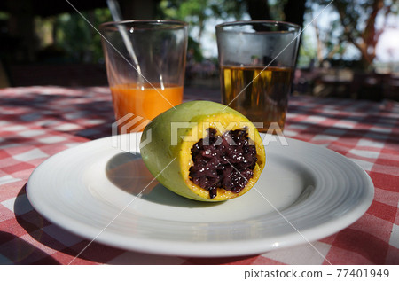 Traditional Thai dessert mango stuffed with red sticky rice. 77401949