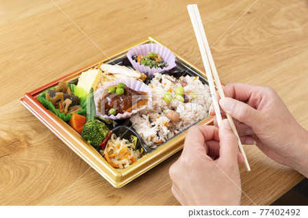 Hands of a woman eating a convenience store lunch Hands of a woman eating a convenience store lunch 77402492